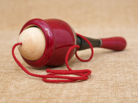 Wooden Child Playing Gilly Ball