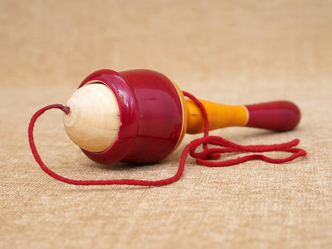 Wooden Child Playing Gilly Ball